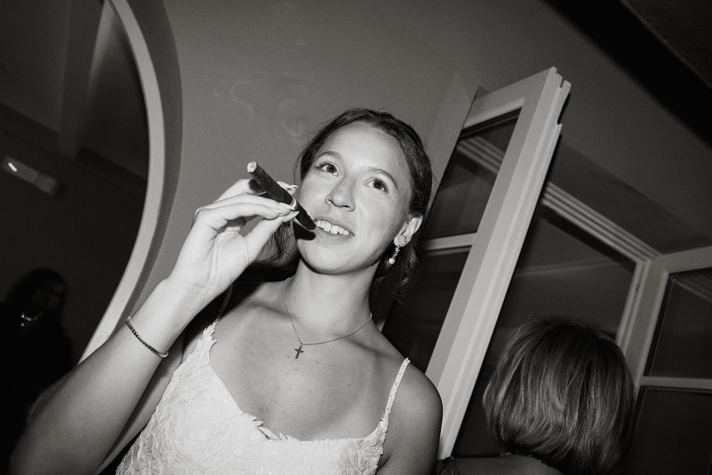 Bride with cigarr during evening reception in Italy