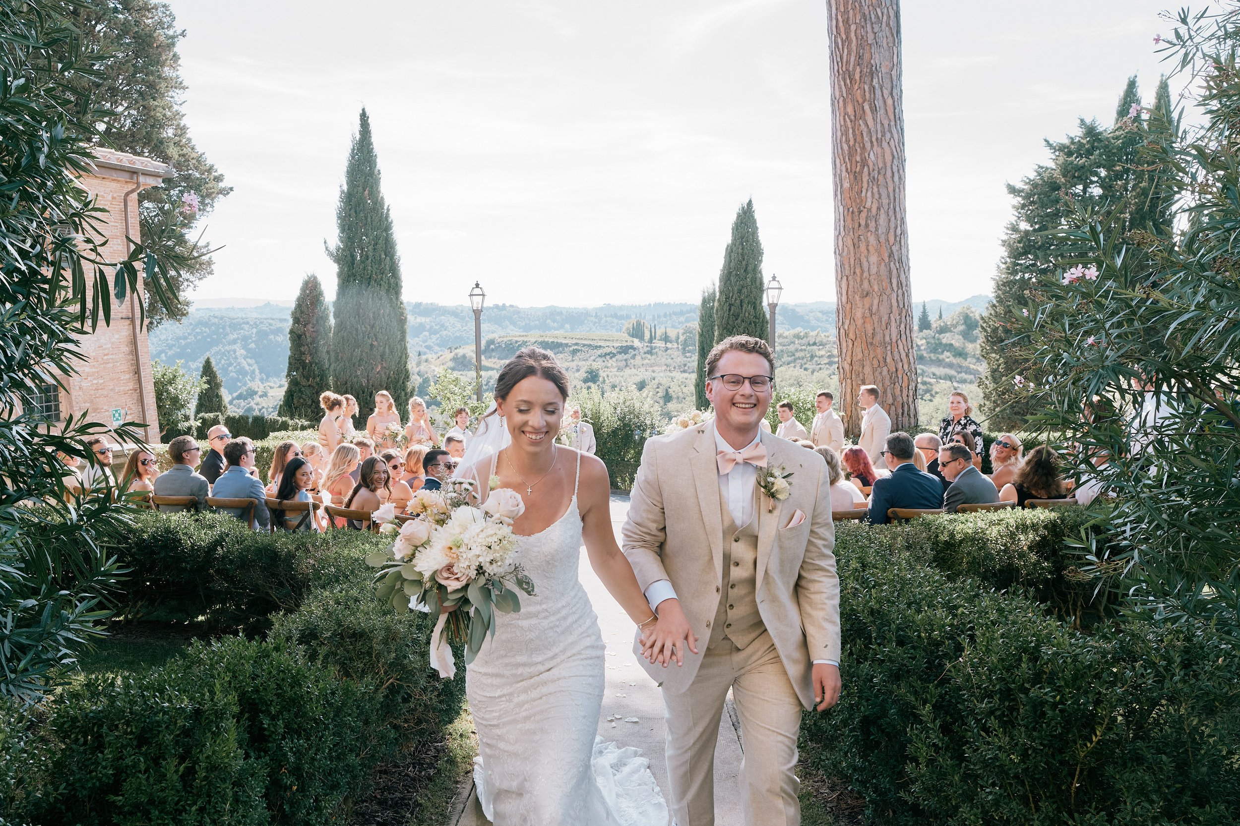 Bride and groom walking down the aisle after ceremony in Tuscany
