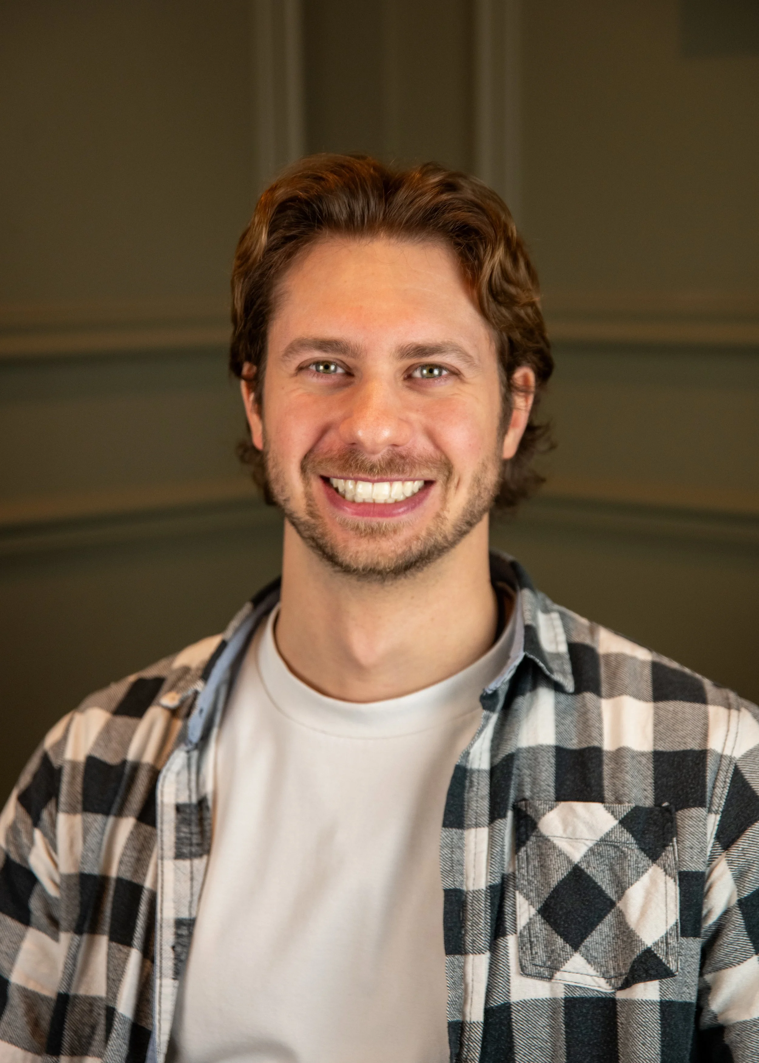 Nat Mortazavi crossed arms red shirt smiling