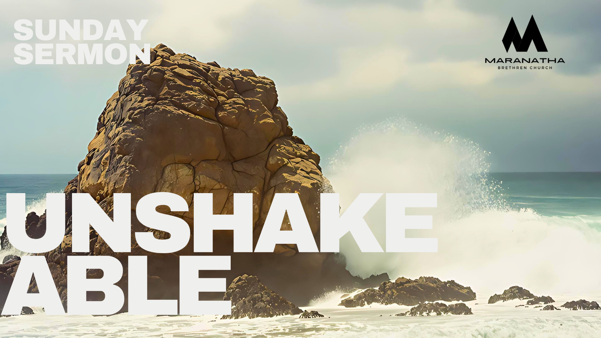 A large rock in the ocean with waves crashing up. Text reads: Sunday Sermon: Unshakeable. Maranatha logo.