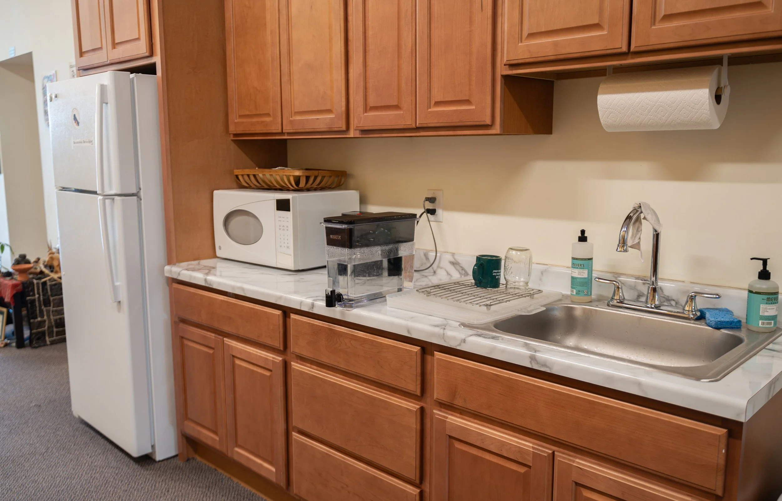 The Institute's kitchenette, equipped with a microwave, tea kettle, refrigerator, and communally available dishware.