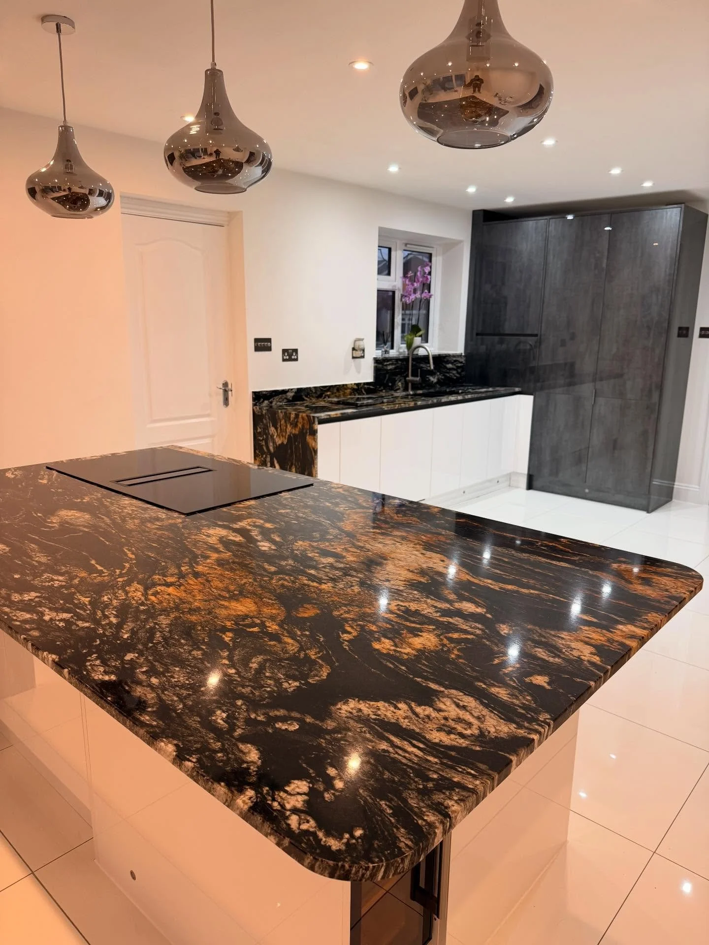 Check out this stunning kitchen! 😍

Titanium gold was used for these worktops and it was the perfect choice!
This kitchen features:
- 2 waterfall end panels
- polished sink + grooves 
- upstands
- windowcill

#dreamkitchen #graniteworktops #kitcheni