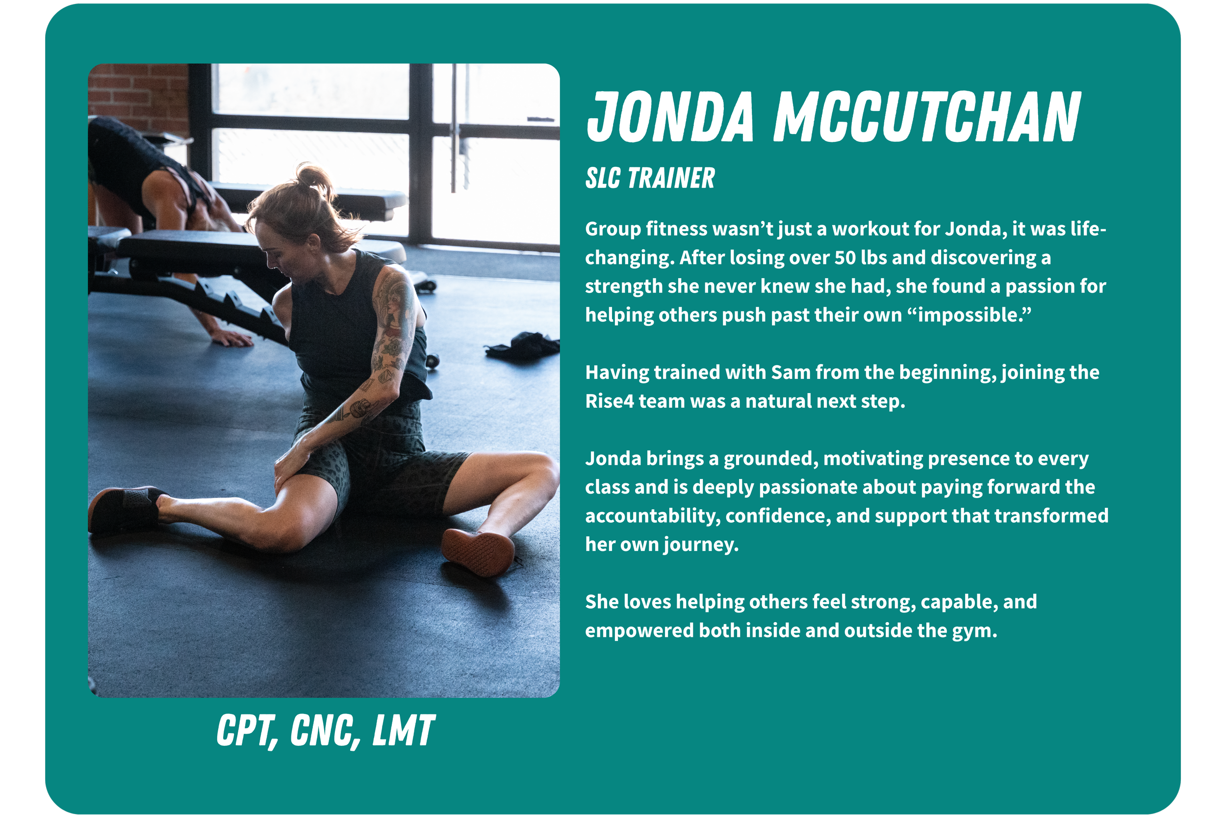 Photograph of a woman with tattoos on her arms sitting on the gym floor, stretching for a workout session. She is wearing a black tank top and patterned shorts, with a bright gym environment in the background.