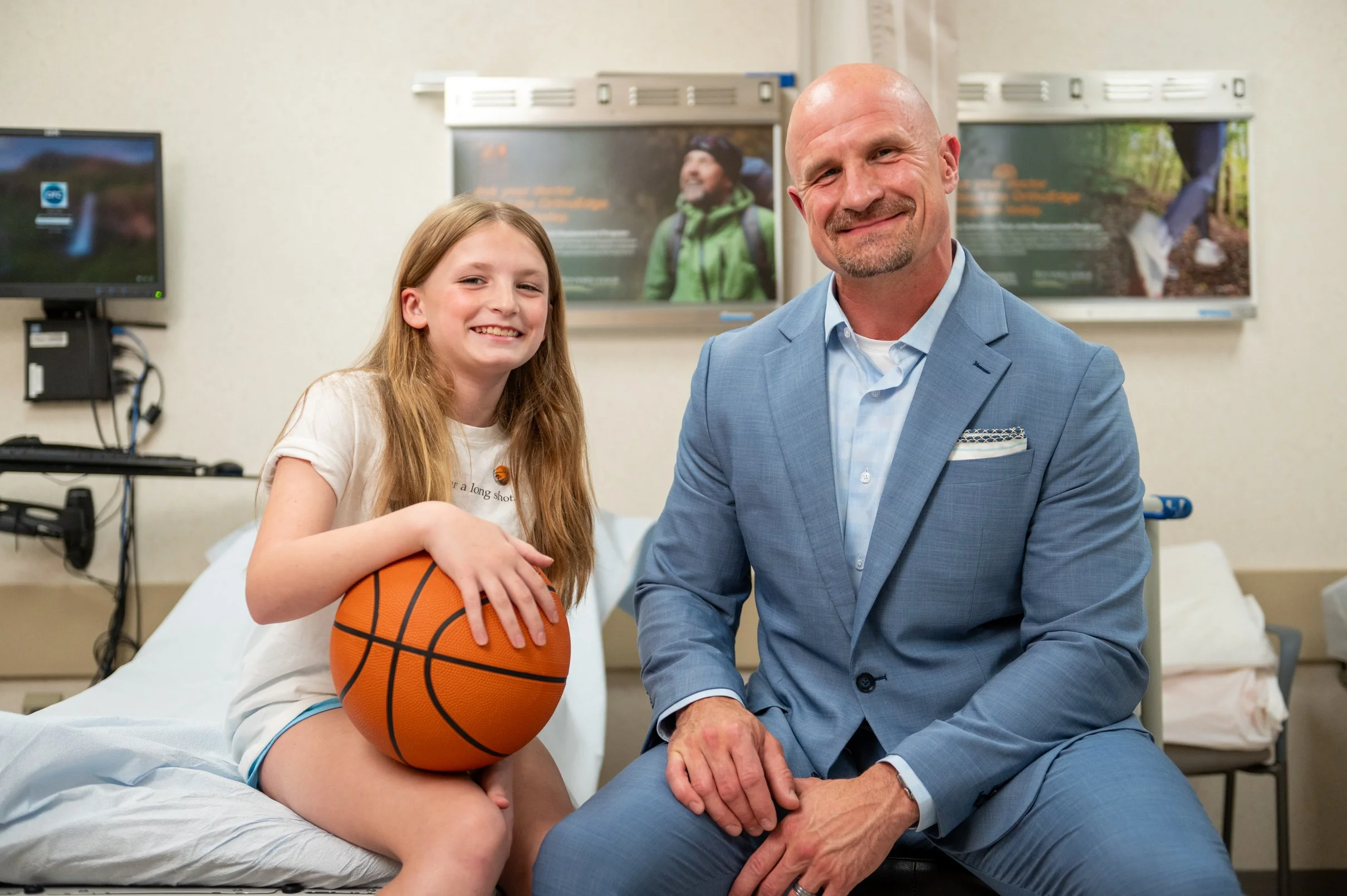 doctor with pediactric patient holding a basketball