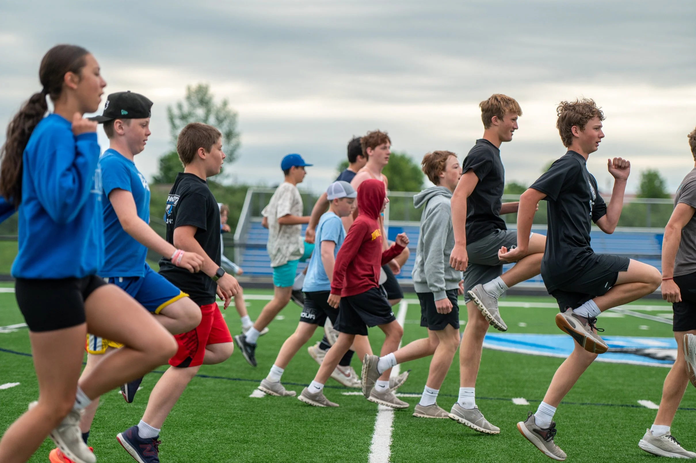 athletes working out on football field