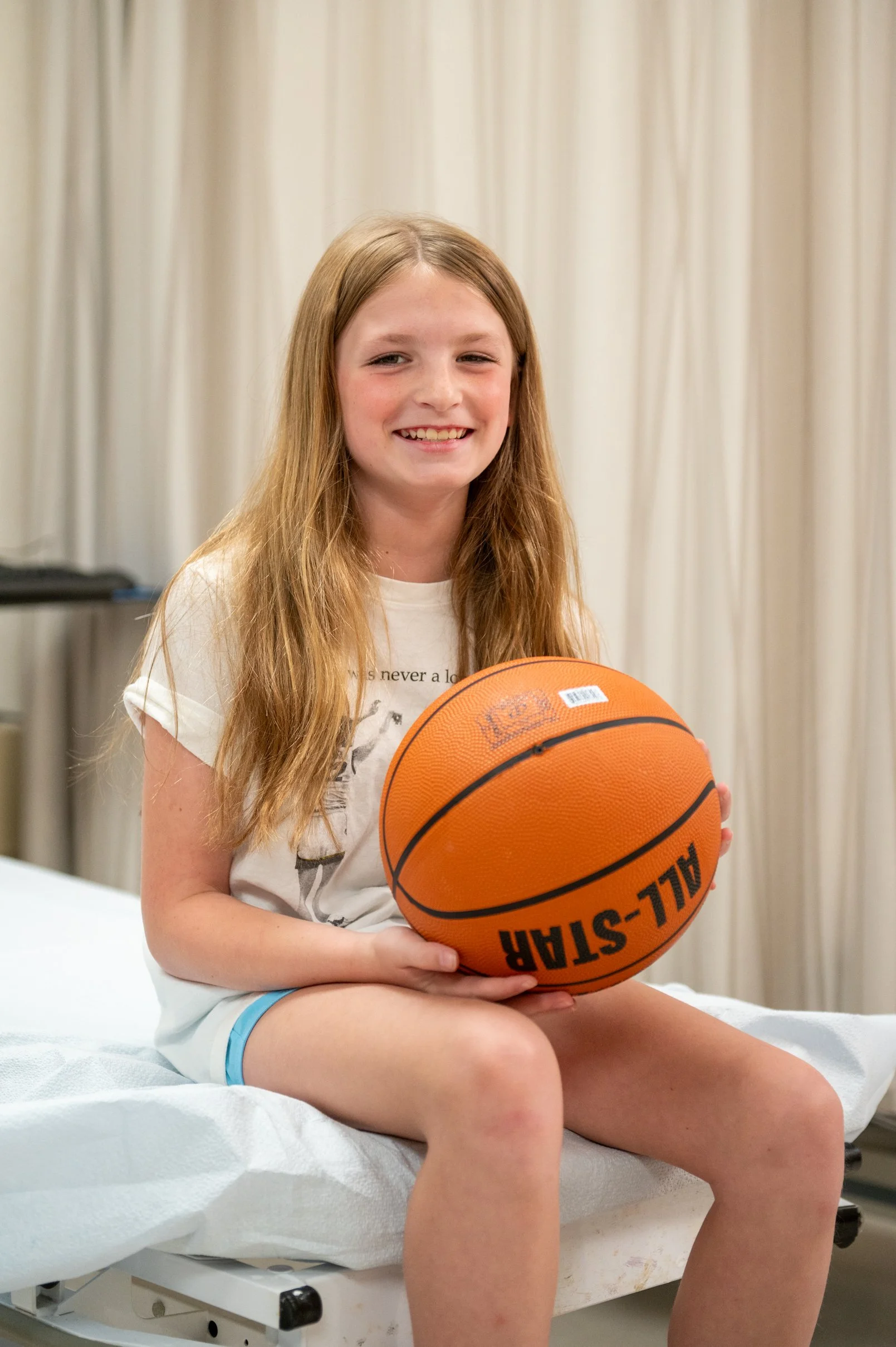 child holding basketball in doctors office