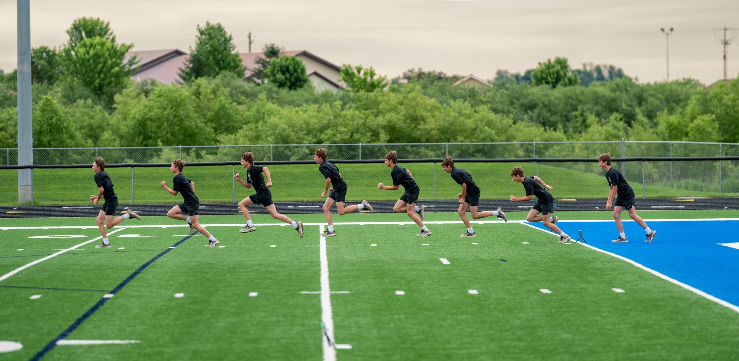 athletes working out on football field
