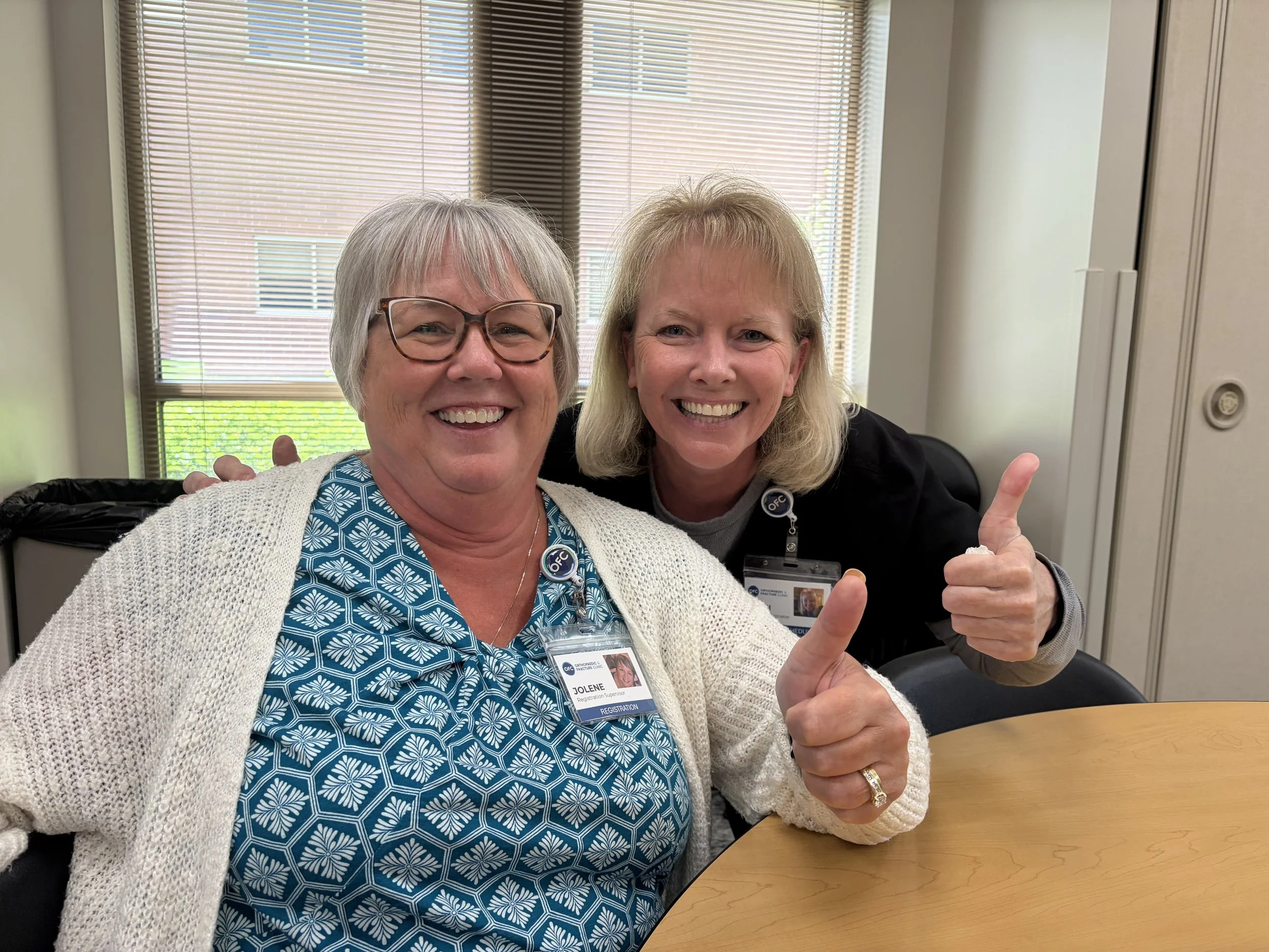 Employees with thumbs up