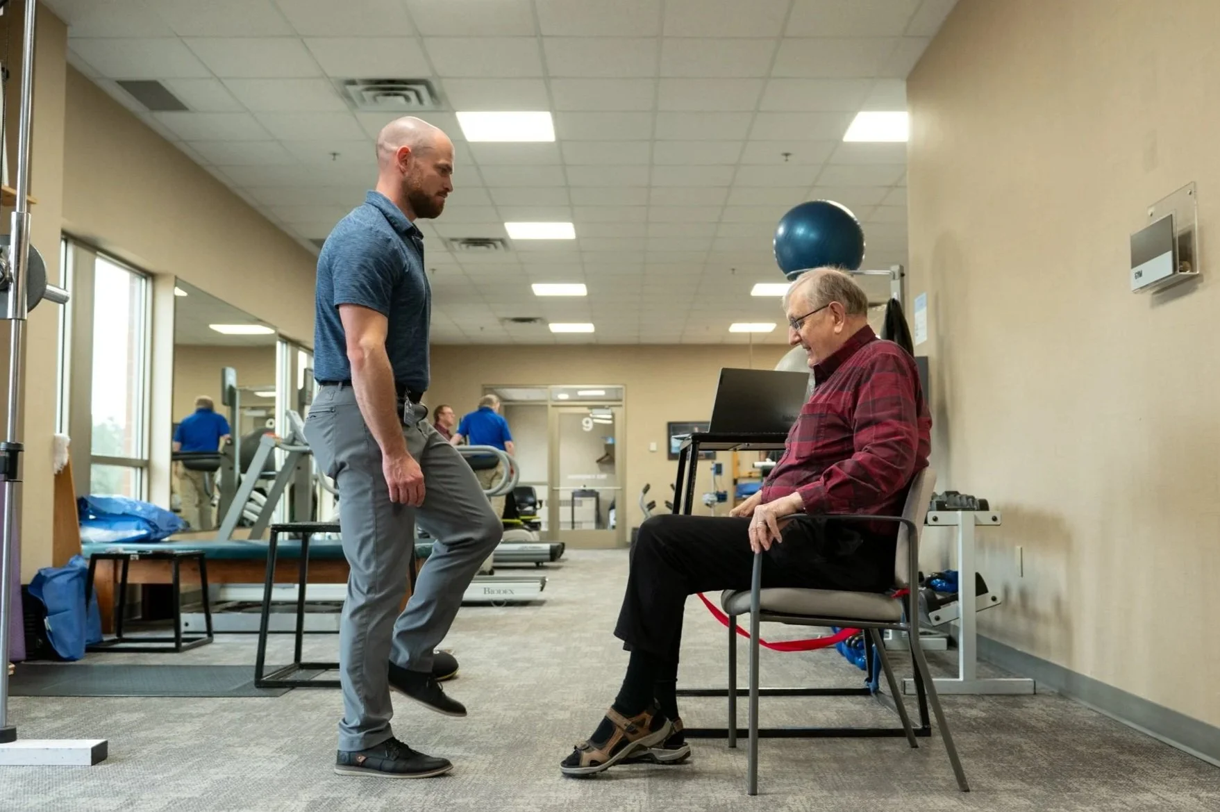 physical therapist working with elderly patient