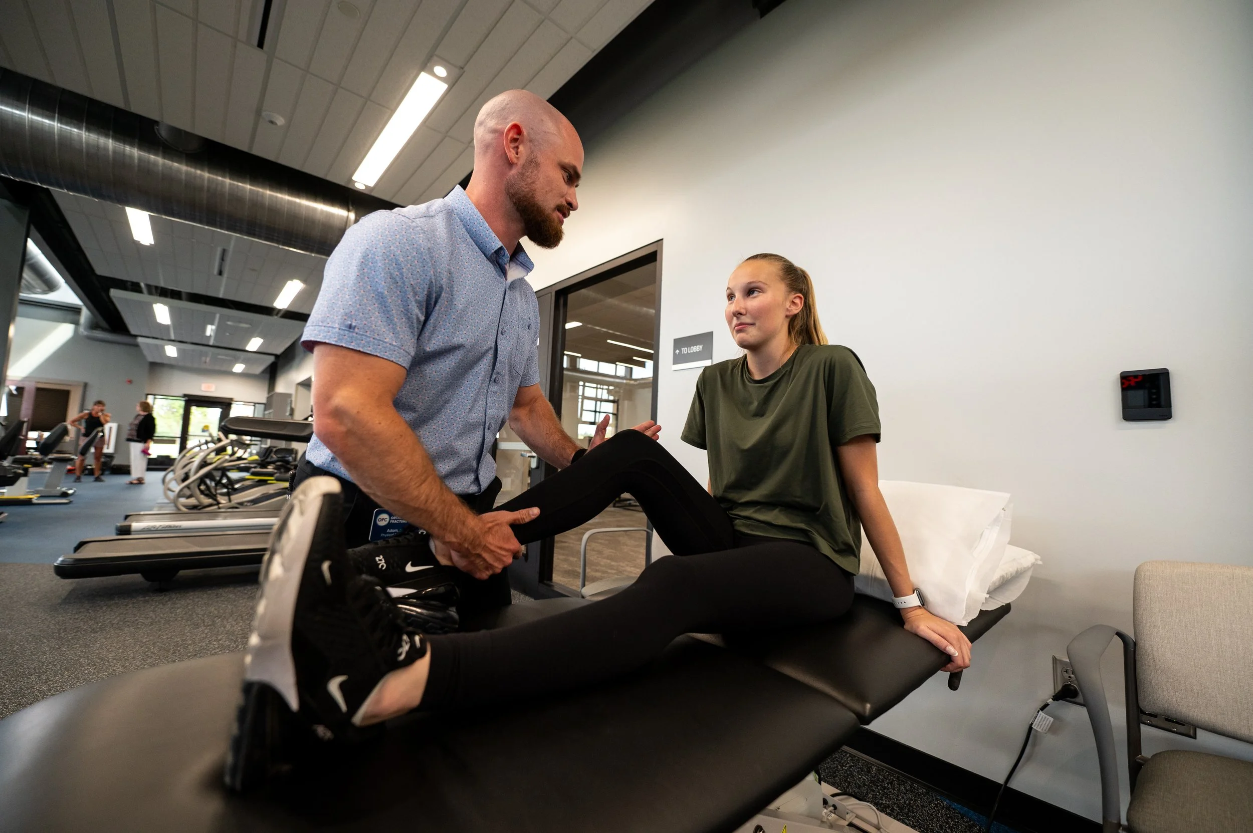 physical therapist working with athlete