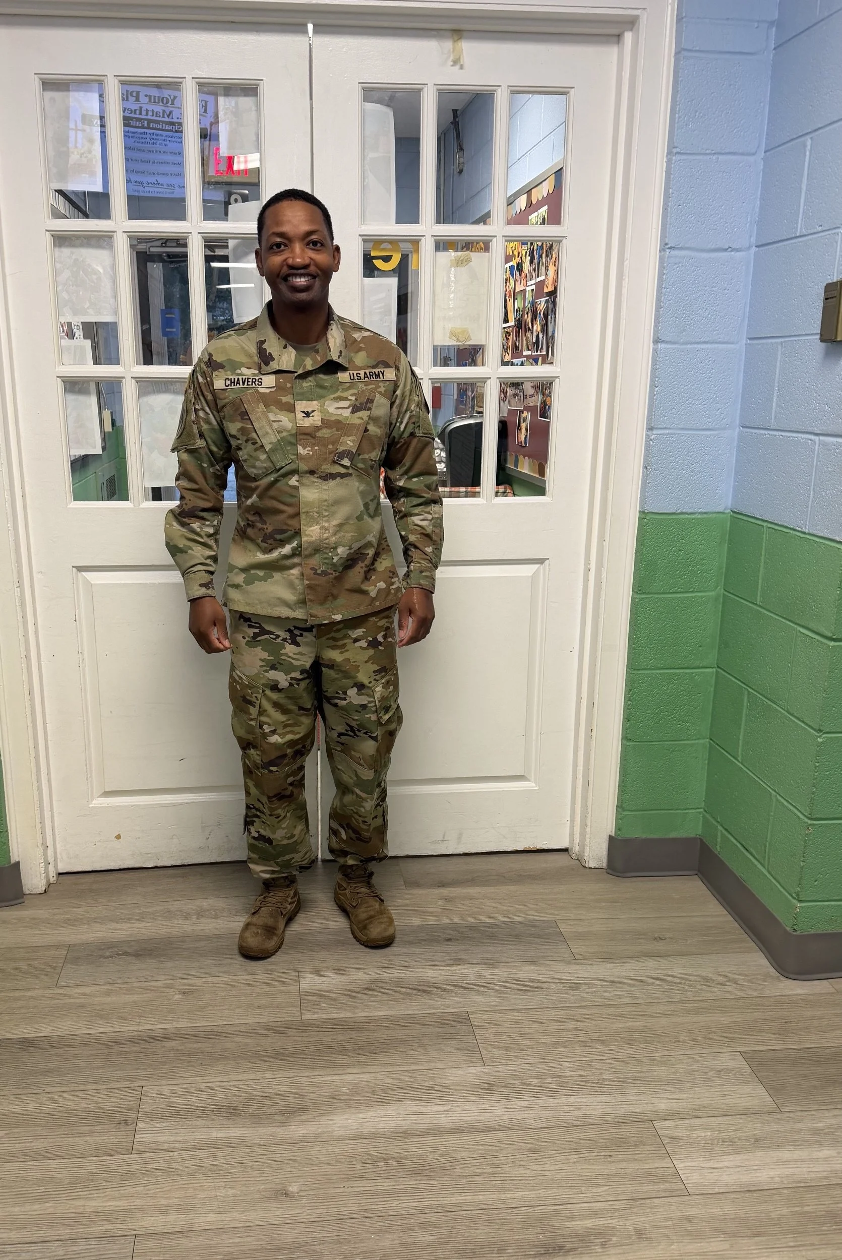 U.S. Army veteran in uniform standing at the entrance of St. Matthew's Weekday School