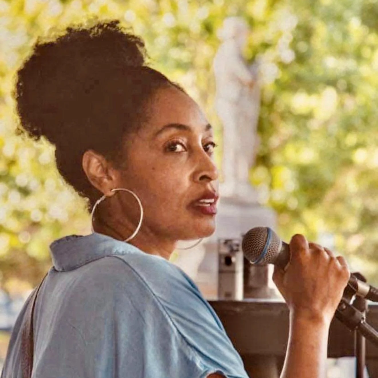 Camille Bennett, a Black woman, addresses the crowd at a Project Say Something/Indigo Girls benefit concert at Lauderdale County Courthouse in Florence, Alabama.
