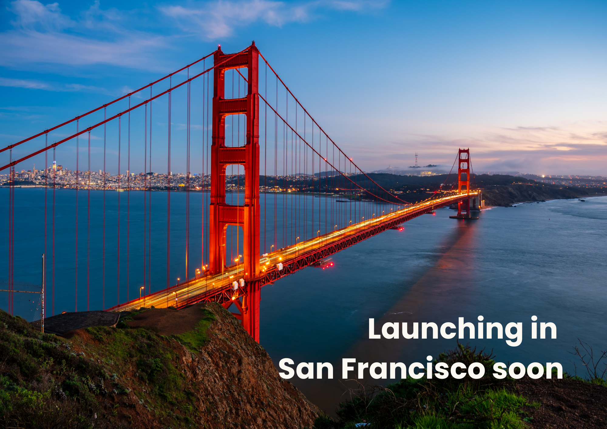 An evening photo of the San Francisco bridge with a view on the bay. 