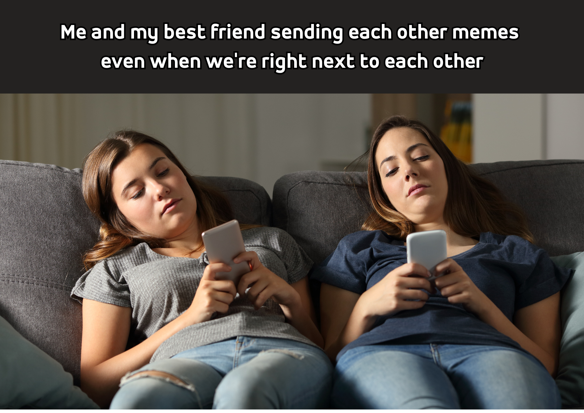 2 girl friends sitting on a couch, looking at their phones.