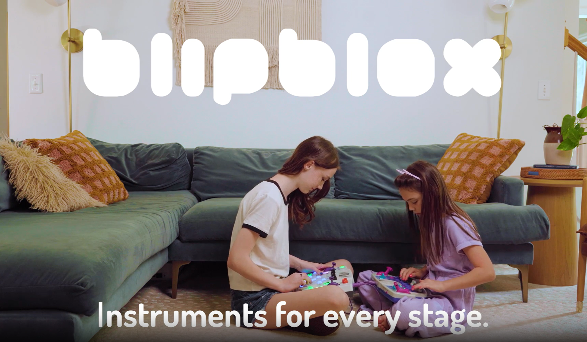 Two children play with Blipblox instruments together in a living room. Text reads Blipblox: Instruments for every stage.