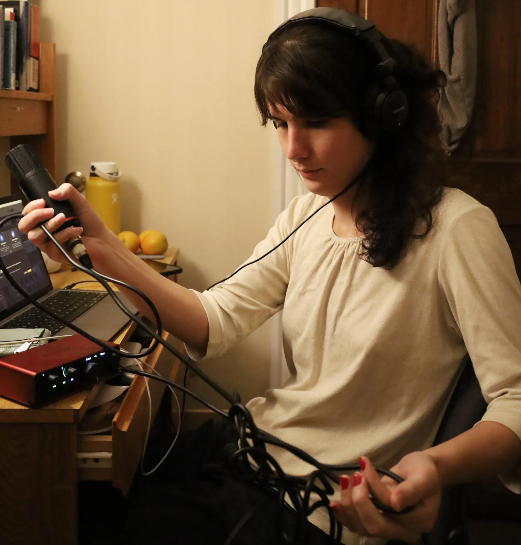 BOSTON, MA--10.15.25--Maggie Ma untangles the cord for her microphone connected to her mini amp, as she prepares to record vocals to an original song in her room.