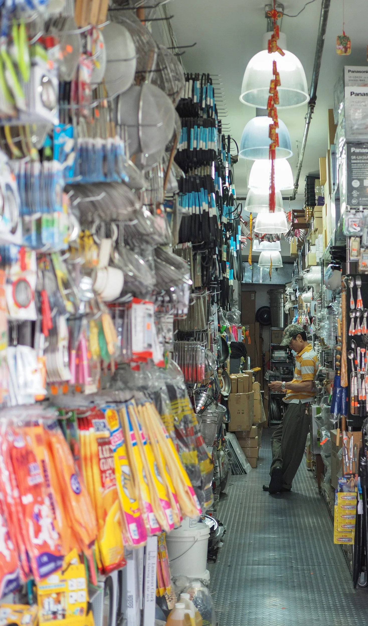 CHINATOWN, NY--A person leans against a shelf in a hardware store in Chinatown. 