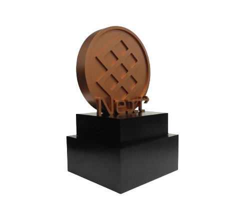 Chocolate expo award trophy with a circular chocolate piece on a black pedestal.