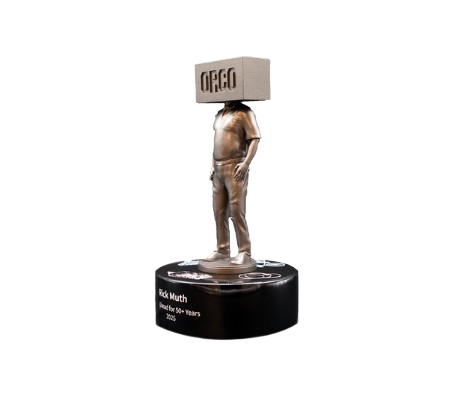 A trophy in the shape of a man holding a box with the ORICO logo, mounted on a circular black base with a nameplate that reads 'Rick Muth, Decades for 50+ Years, 1965-2015'.