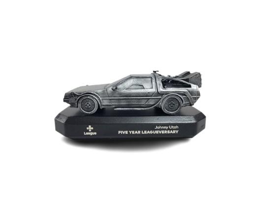 Model of the DeLorean time machine from the movie "Back to the Future" on a display stand celebrating the five-year league anniversary.
