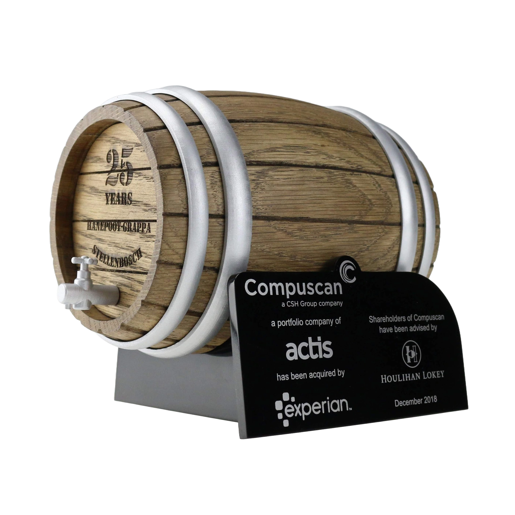 A mini wooden barrel with metal bands and a small faucet, displayed on a stand with a black plaque showing company logos and text.