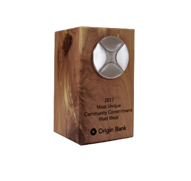 A wooden award with a metal emblem and engraved text, including the year 2017, the name Matt West, and the company Origin Bank.