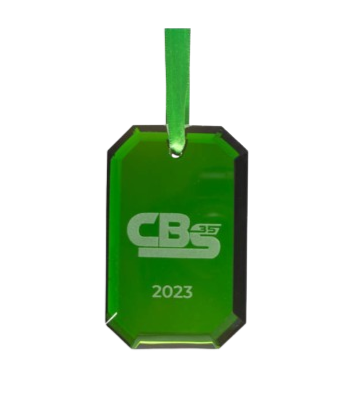 Green glass award with the logo 'CB 35' and the year '2023' engraved on it, hanging from a green ribbon.