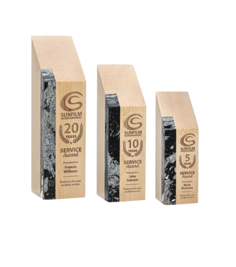 Three rectangular awards made of wood and marble with engraved logos and text, commemorating 5, 10, and 20 years of service from Sunfilm Entertainment.