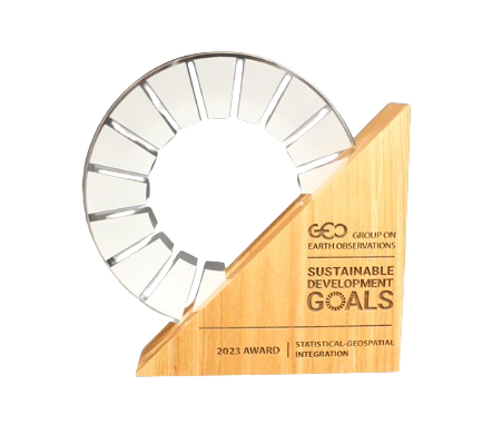 A wooden award plaque with a curved top, featuring an inset clock face with no hands, and inscribed with 'GEO Group on Earth Observations, Sustainable Development Goals, 2023 Award, Statistical-Geospatial Integration'.