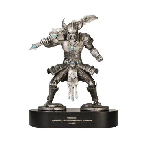 A detailed statue of a warrior with horned helmet, armor, and a weapon, mounted on a round black base engraved with text, set against a white background.