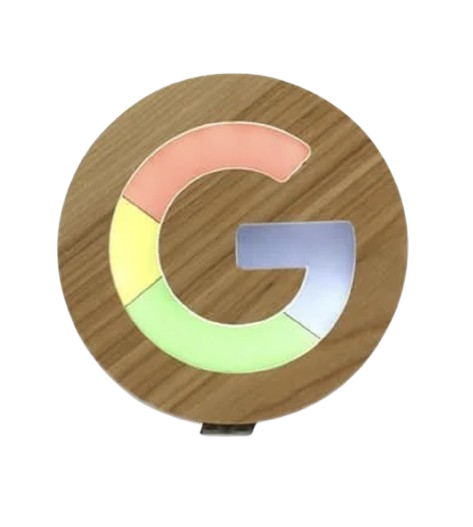 A Google-themed wooden lamp shaped like the letter G with colorful segments in pink, yellow, and green.