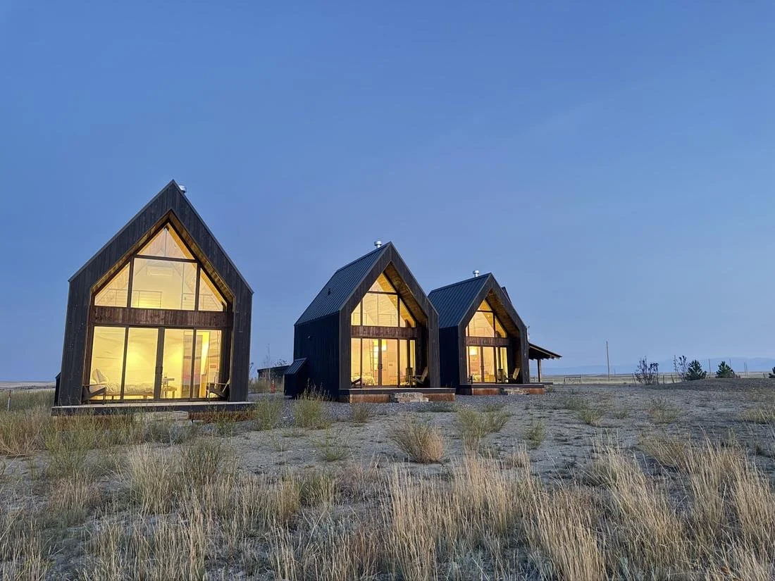 Reed Retreat cabins lit from within at dusk