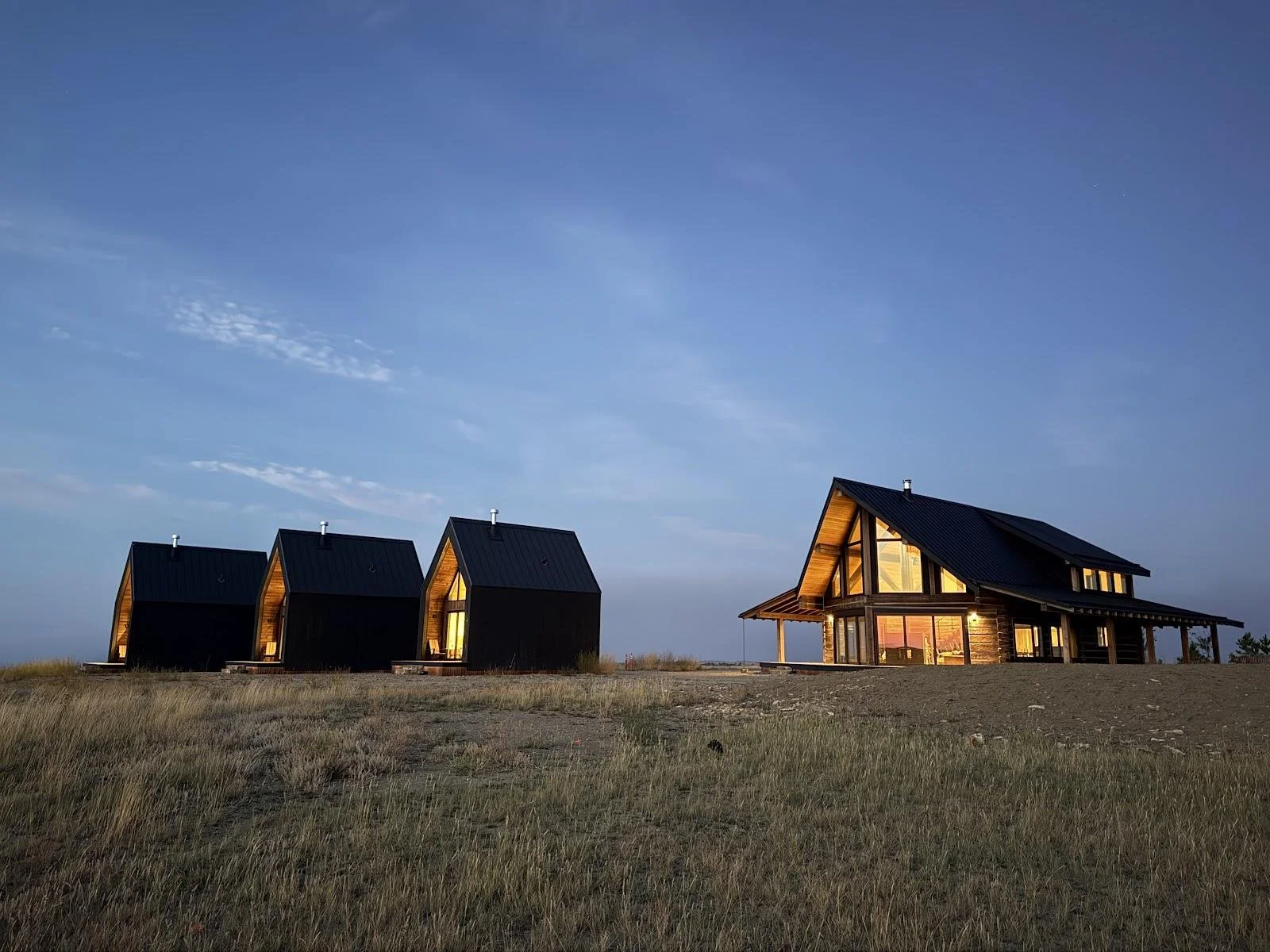 Reed Retreat main residence and three cabins at twilight, Reed Point, Montana
