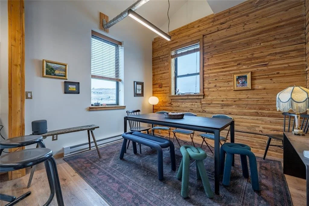 Granary apartment dining area with wood plank wall