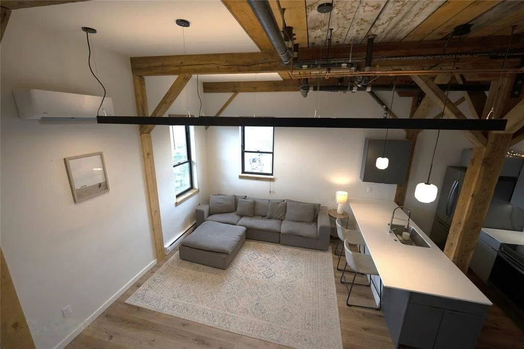 Apartment living room inside The Granary in Livingston, Montana, with the original timber beams left exposed