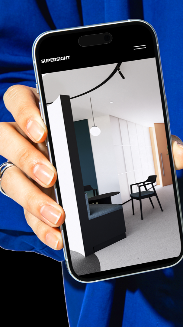 A person holding a smartphone displaying a minimalist interior design of a modern room.