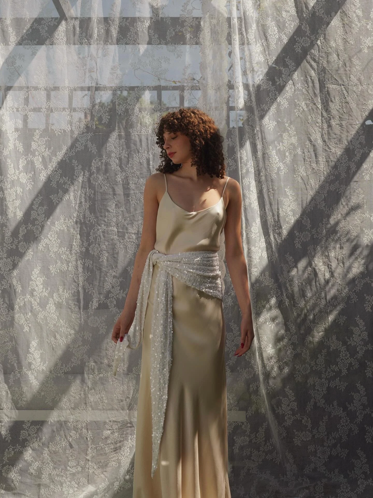 Simplicity, with a twist! Our Silk Satin slip dress in Blush can we styled so many ways to suit you personal style, here it&rsquo;s worn with a sequin scarf belt for a fun fashionable twist!

Get in touch to book your appointment in our London Boutiq