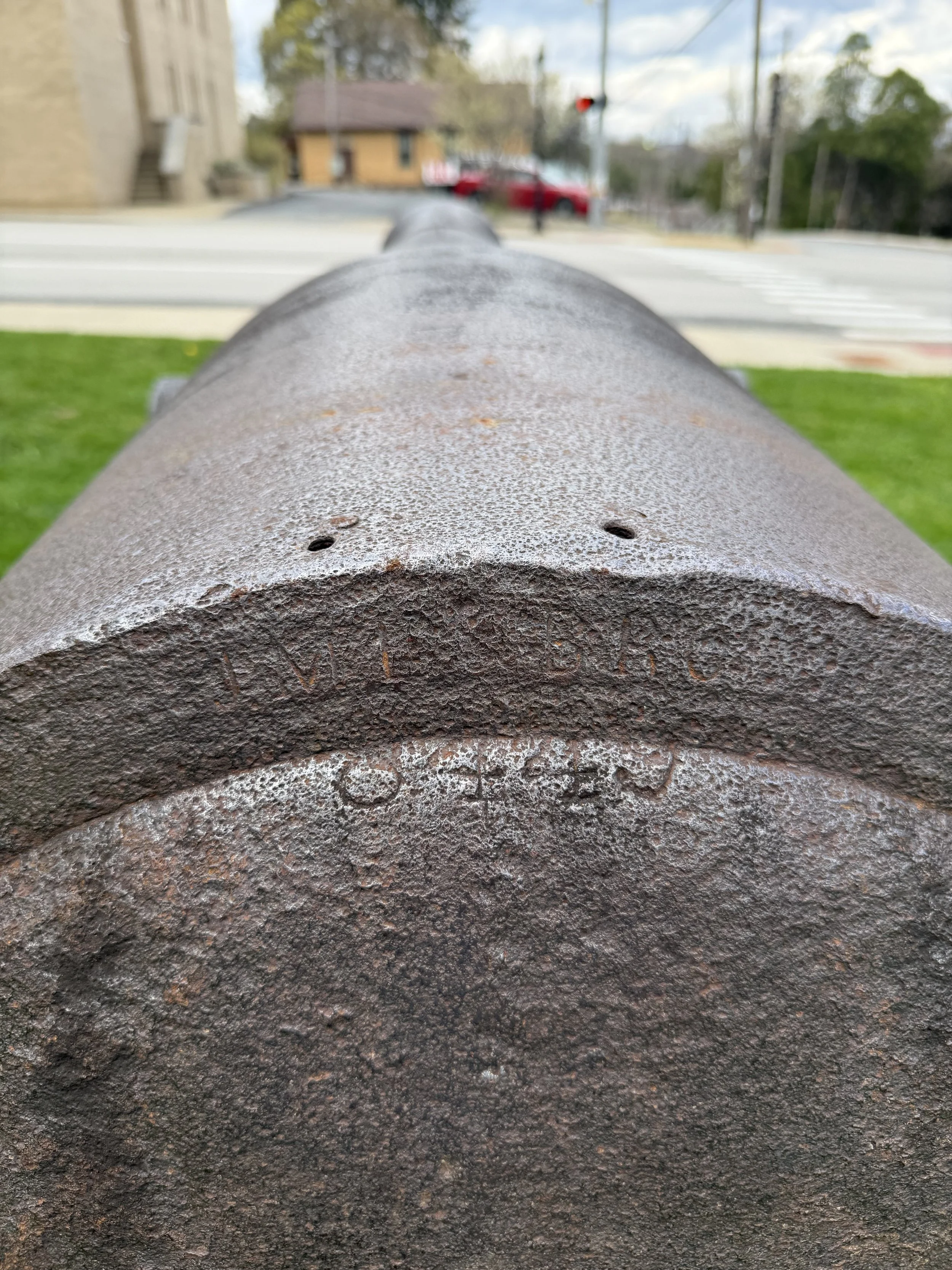 The original weight of the piece, 8,445 pounds, is stamped on the breech.  The firm that banded the rifle, J.M. Eason and Brothers, is stamped on the rear of the wrought iron reinforcing band.