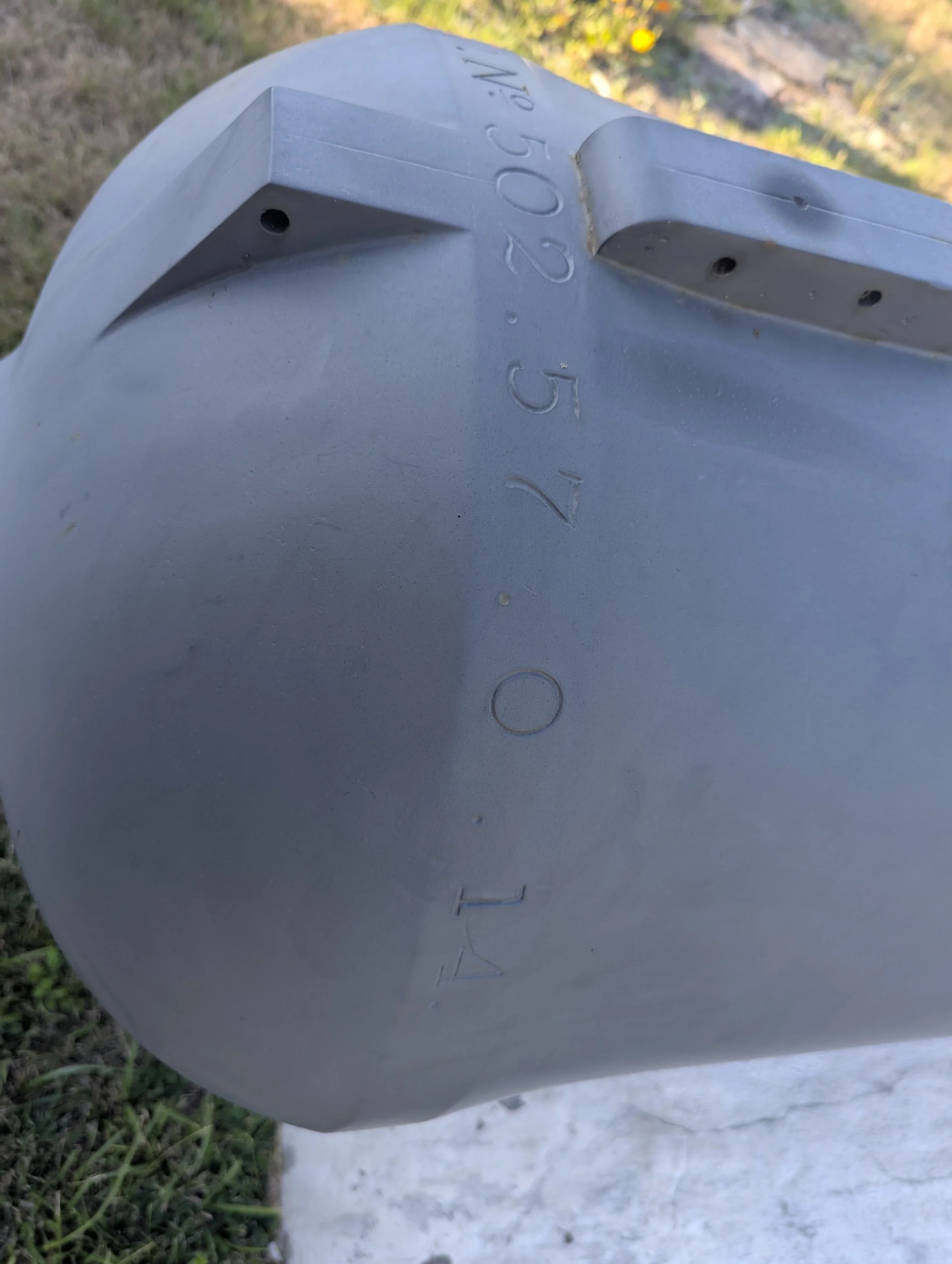 The weight, 57-0-14 hundredweight (6,398 pounds), is also stamped on the base ring.