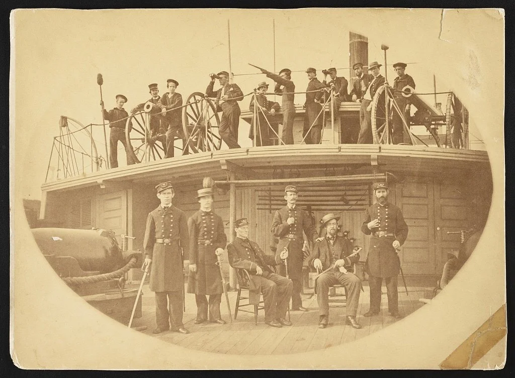 Sailors and officers aboard USS Hunchback.  Note the rifled boat howitzer at left on the upper deck and the smoothbore 12-Pounder Boat Howitzer to the right.