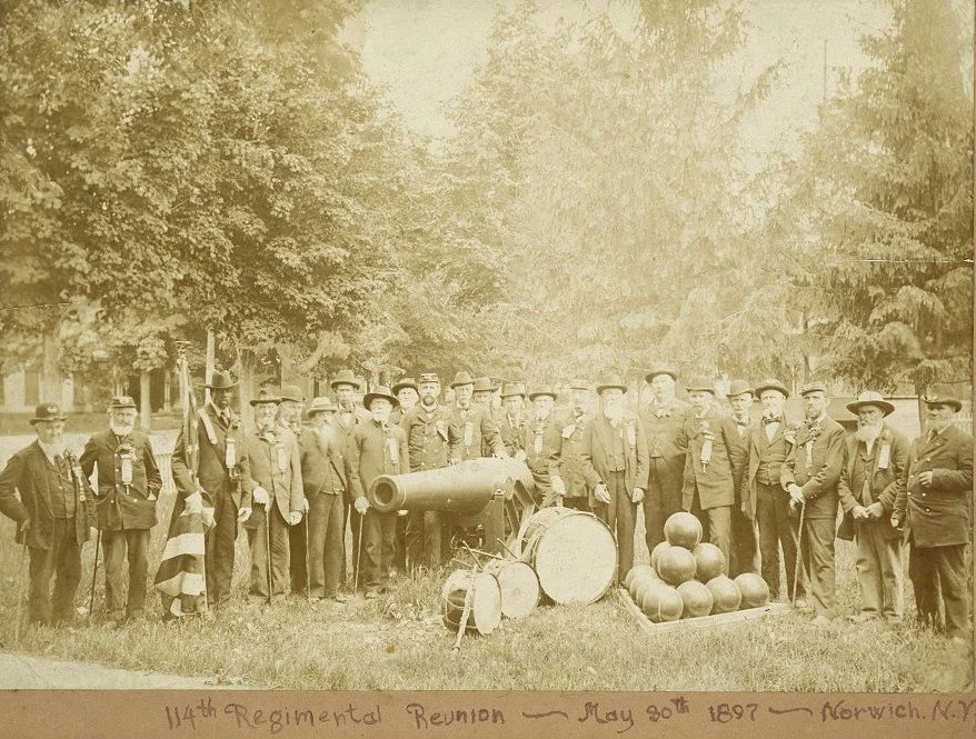 114th New York Reunion Veterans standing around a US Navy cannon likely recently placed as a memorial in Norwich, New York.