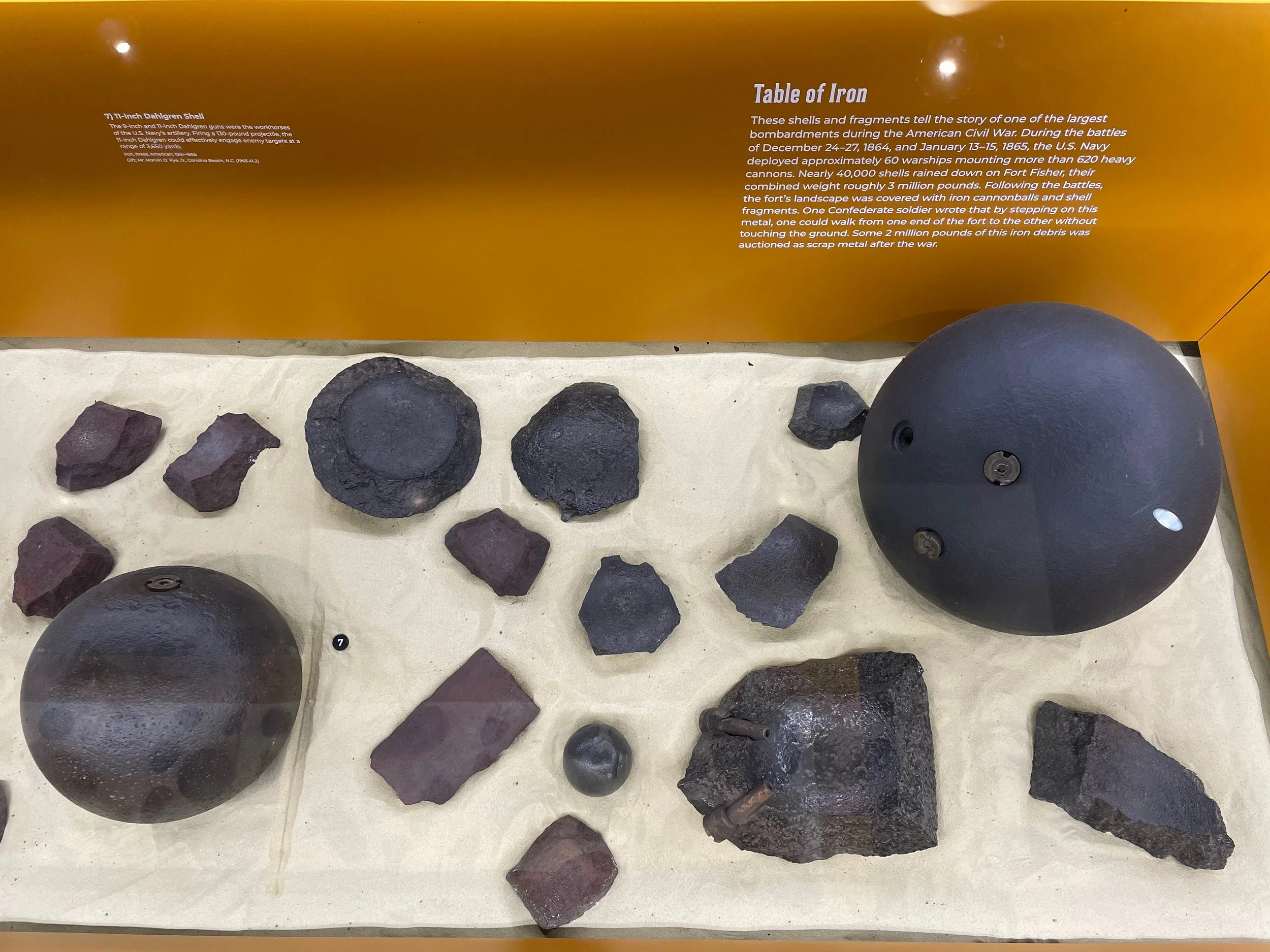 A giant 15-Inch Shell of the type fired by USS Canonicus is the largest projectile in the display of US Navy projectiles and fragments displayed at Fort Fisher State Historic Site (2025 photos).