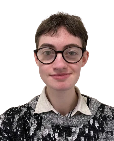 A person with short brown hair, glasses, a white shirt and grey and black sweater