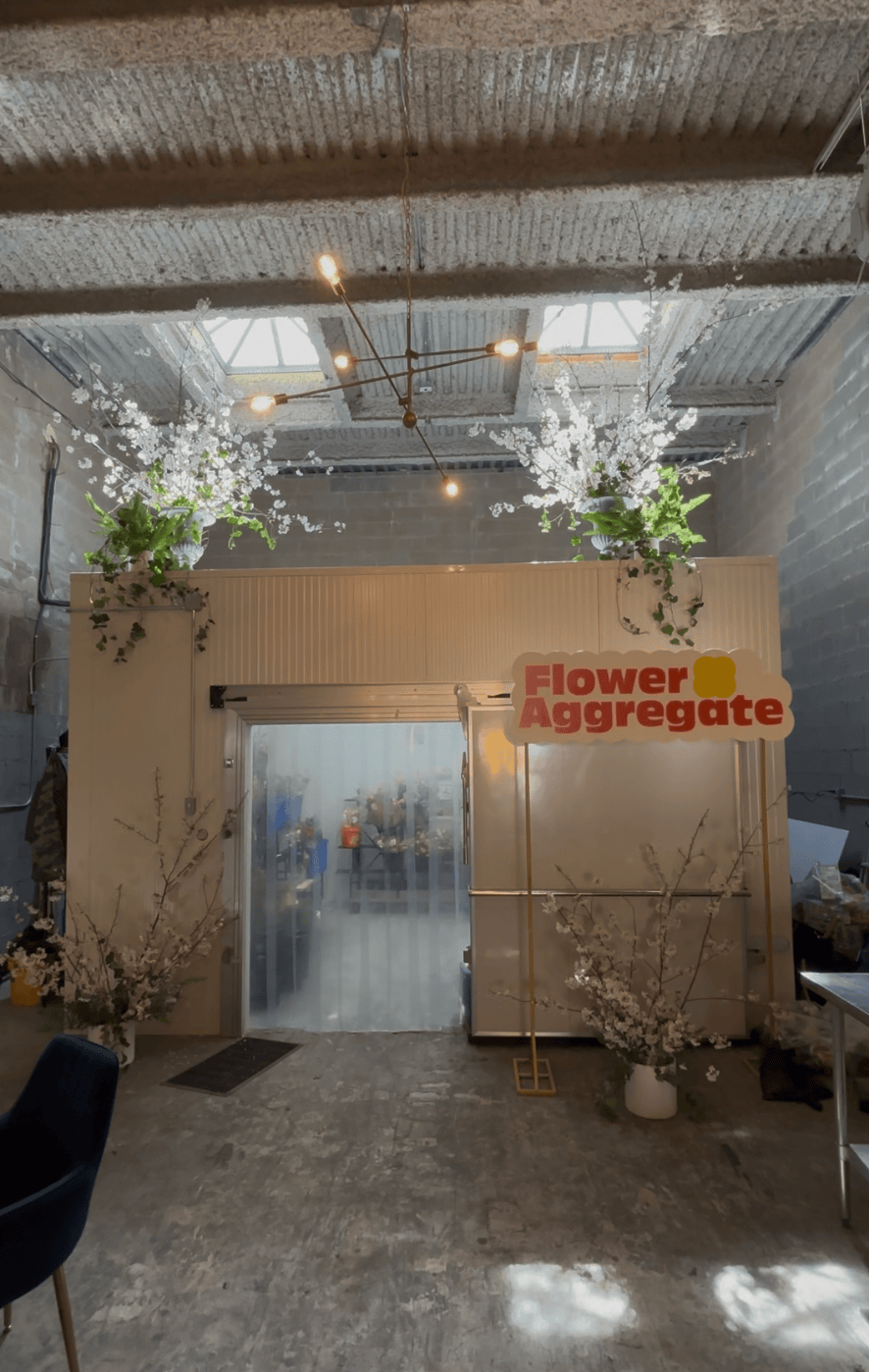 Our home, 'Flower Aggregate,' decorated with locally-sourced white blossoms and greenery, and illuminated by industrial-style chandelier lighting.