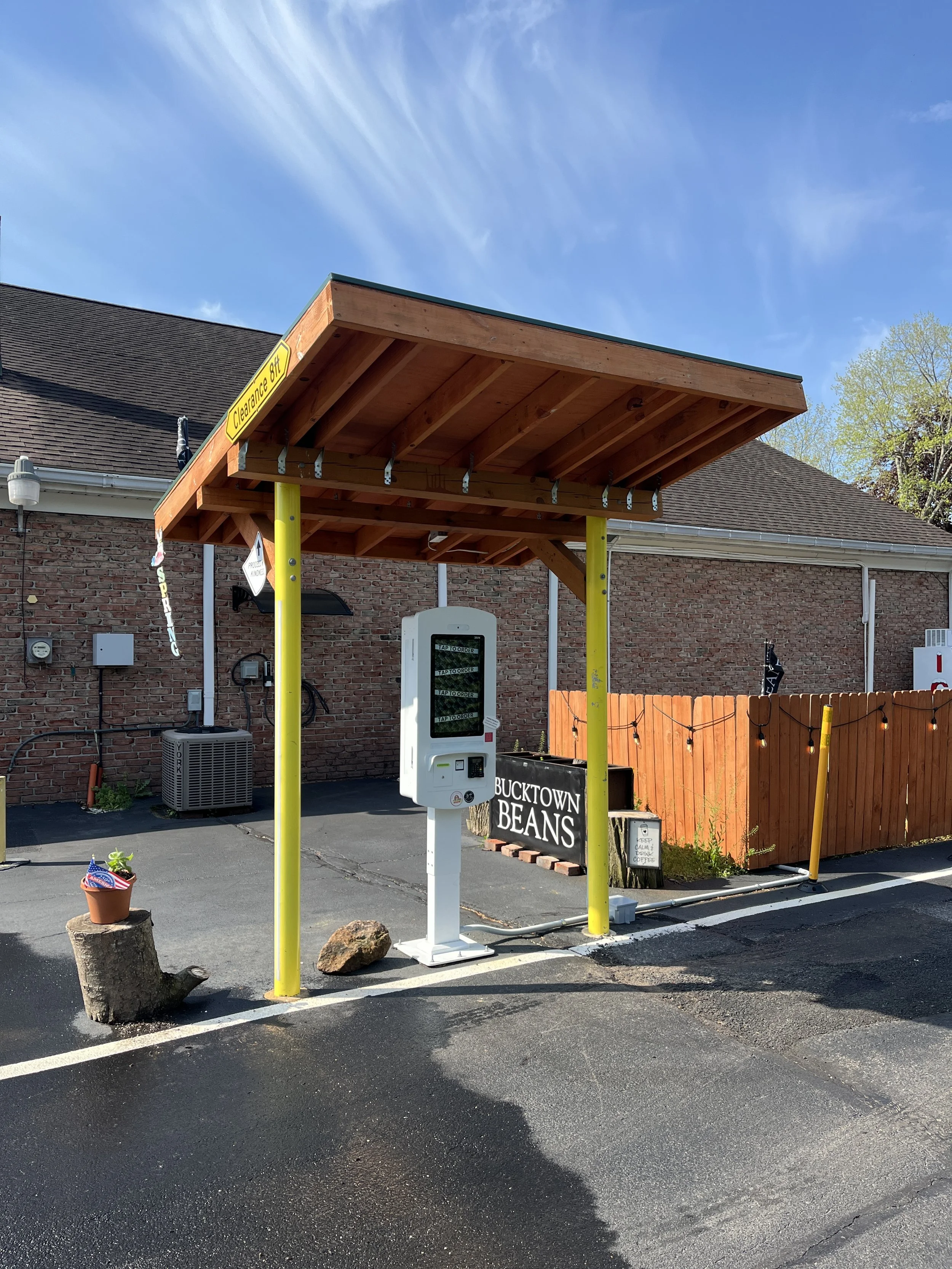 White Outdoor Kiosk Under a Covered Awning