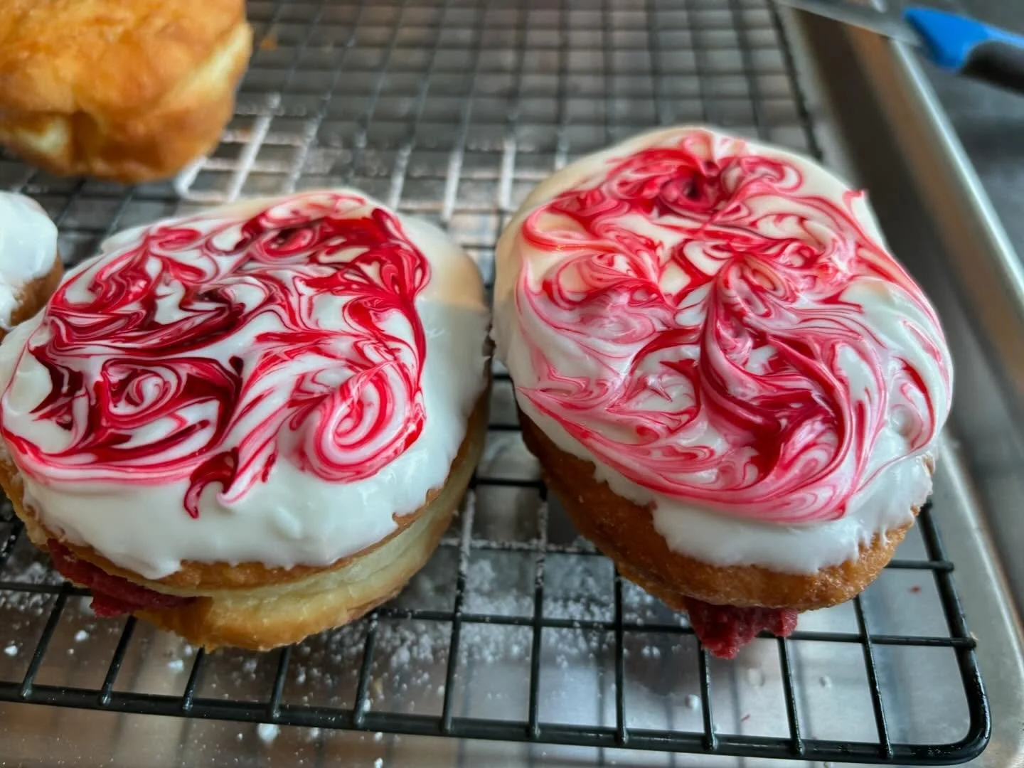 Introducing The What Is That&hellip;Velvet??? Vanilla glaze and psychedelic swirls filled with red velvet cr&egrave;me. Limited run and only available this Sunday at the CoLab. Get two free Super Bowl squares with any purchase.