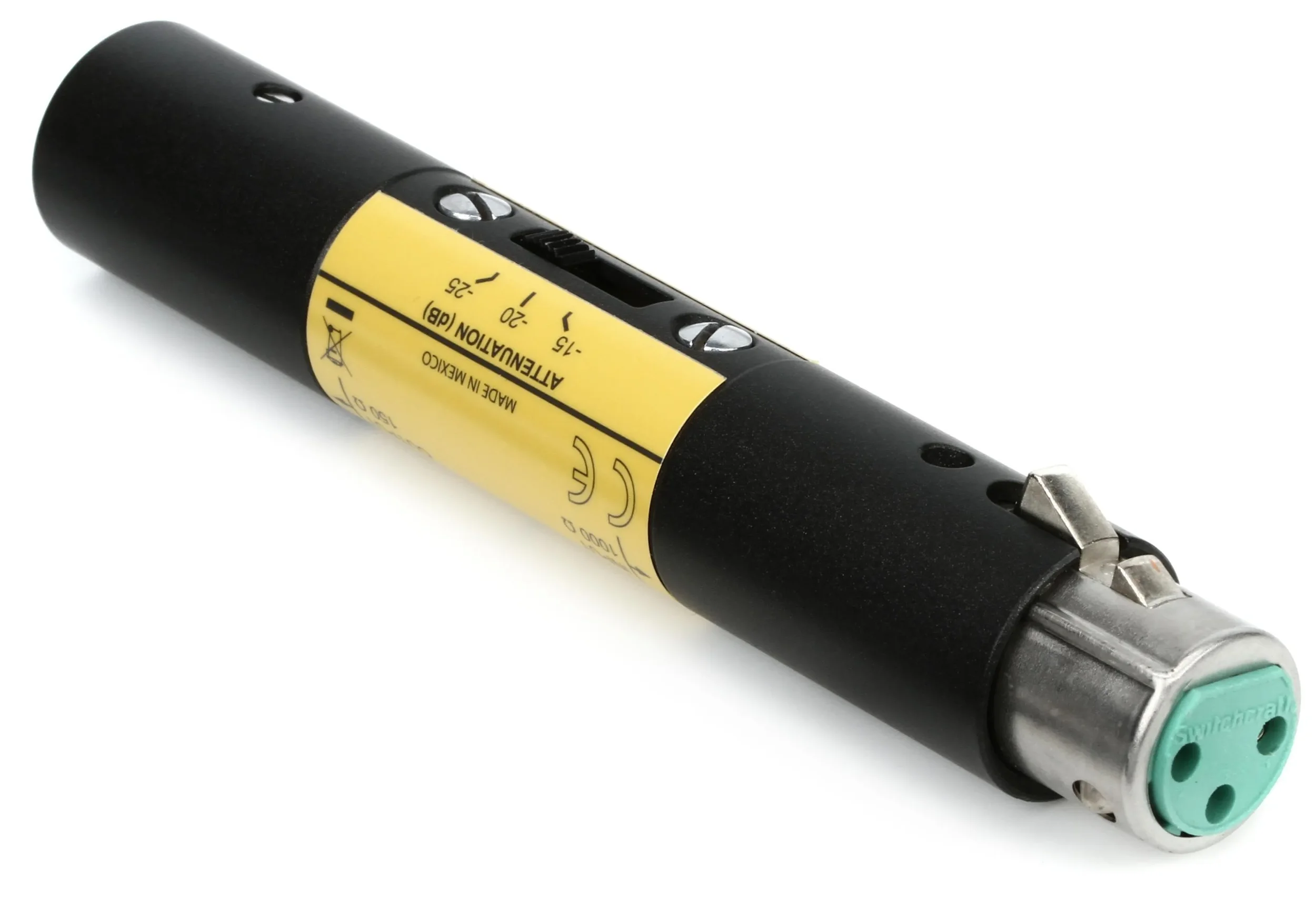 A close-up of a black insulin pen with a yellow label, metal tip, and green cap, lying on a white surface.