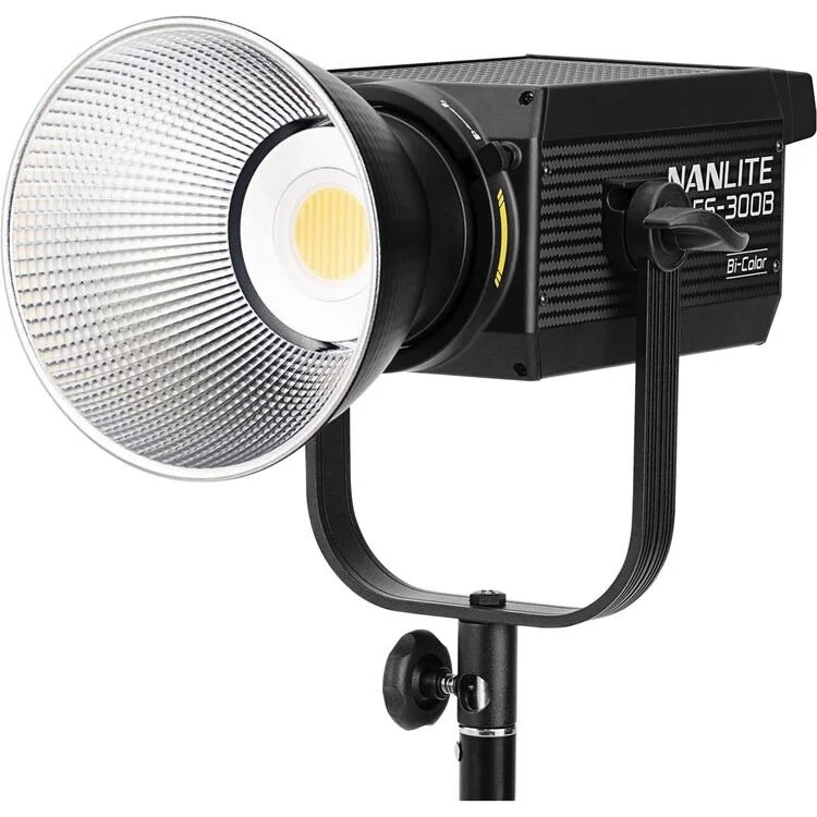 A professional studio strobe light with a reflective dish and adjustable stand.