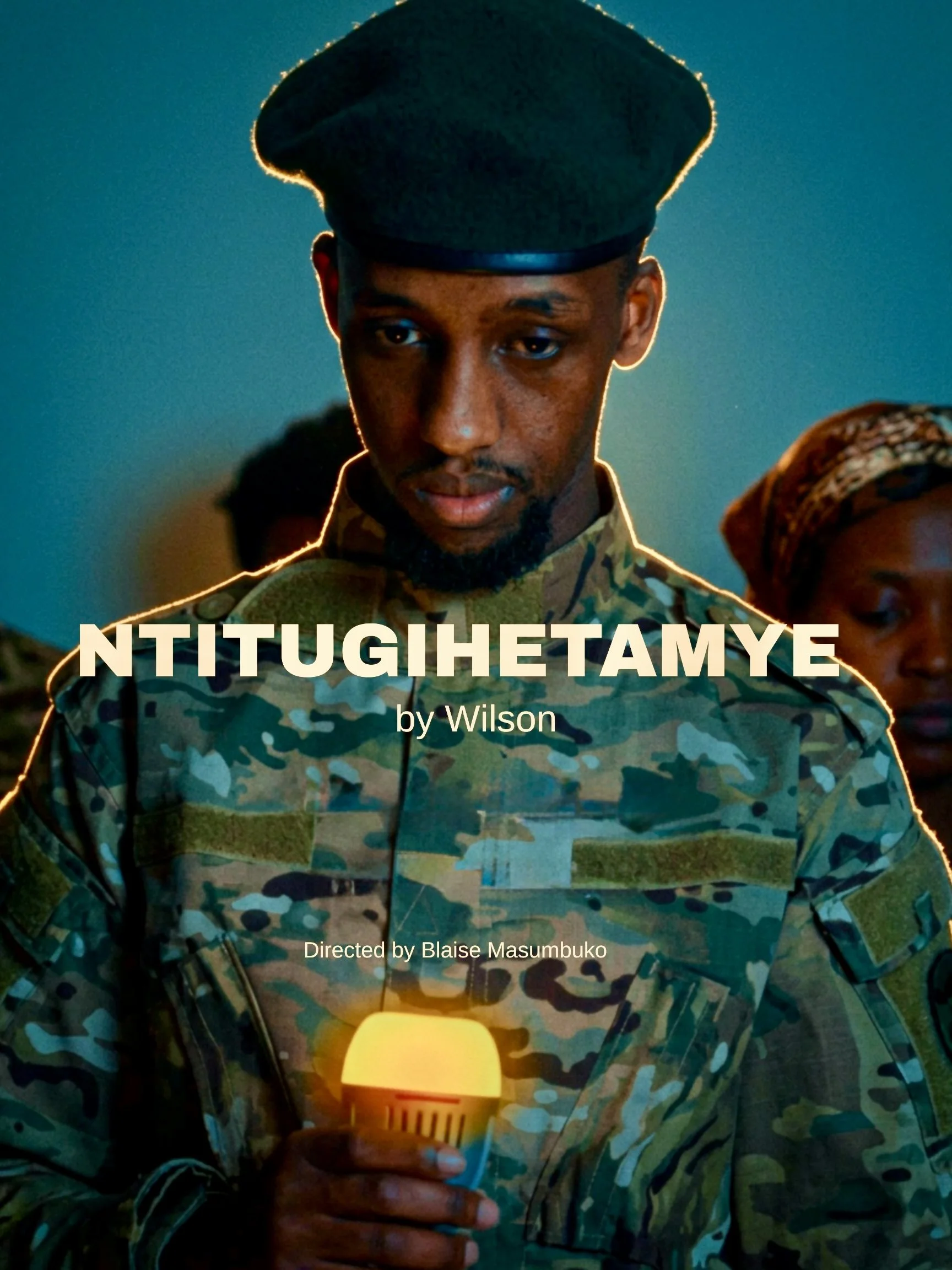 A person dressed in military camouflage holding a lit candle inside a lantern.