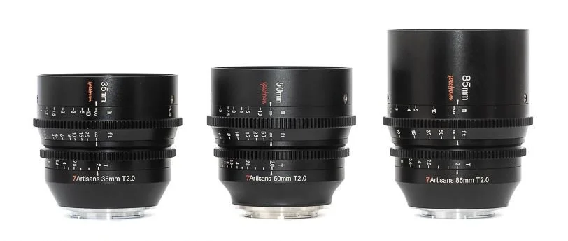 Three camera lenses of different focal lengths arranged side by side on a white background.